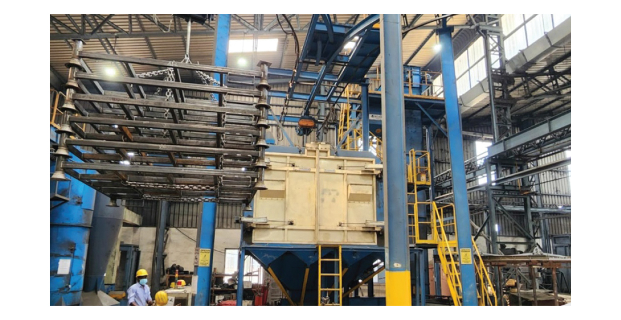 CNC automatic shot blasting machine used for surface preparation and metal cleaning at Mekins Industries