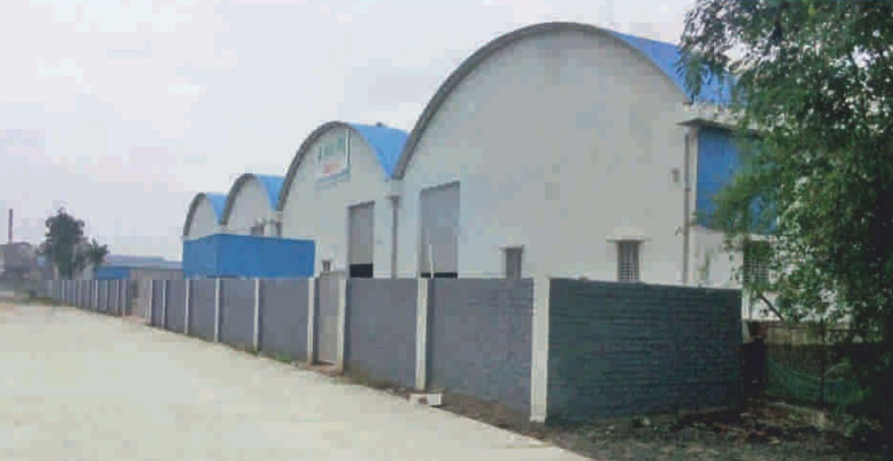 Mekins Industries Sanand Ahmedabad manufacturing unit joint venture with Paul Mueller GmbH featuring factory sheds and industrial setup