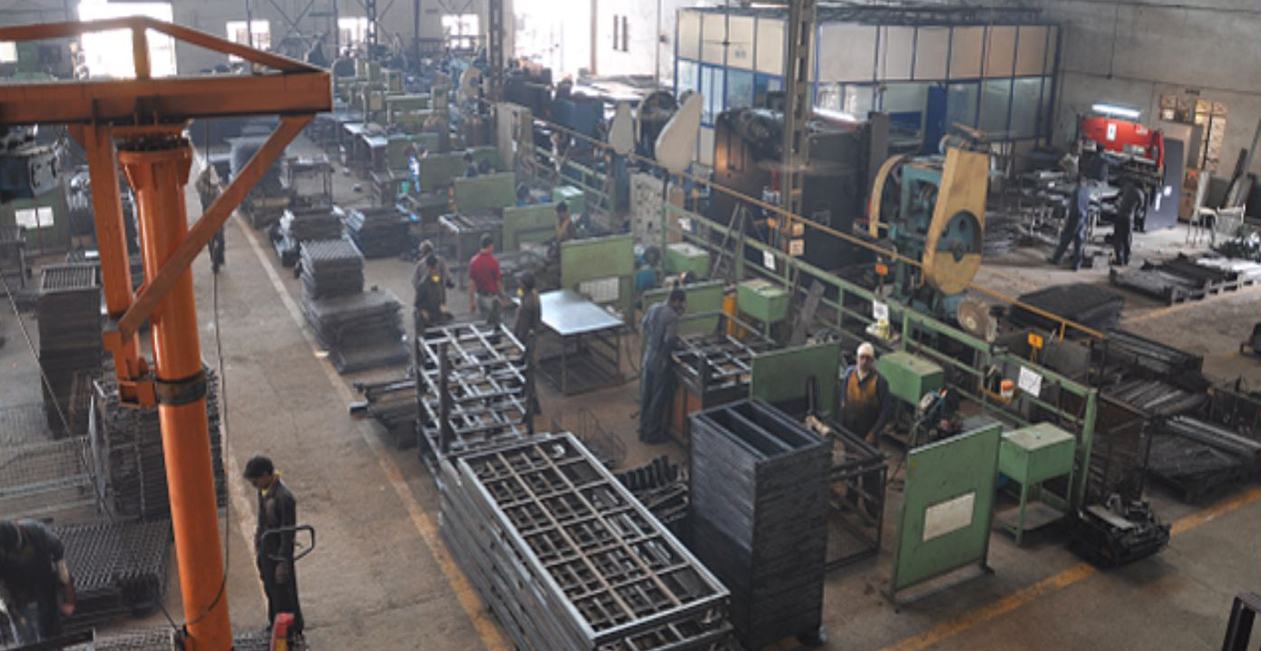 Welding section at Mekins Industries showing technicians working on metal fabrication with industrial machinery